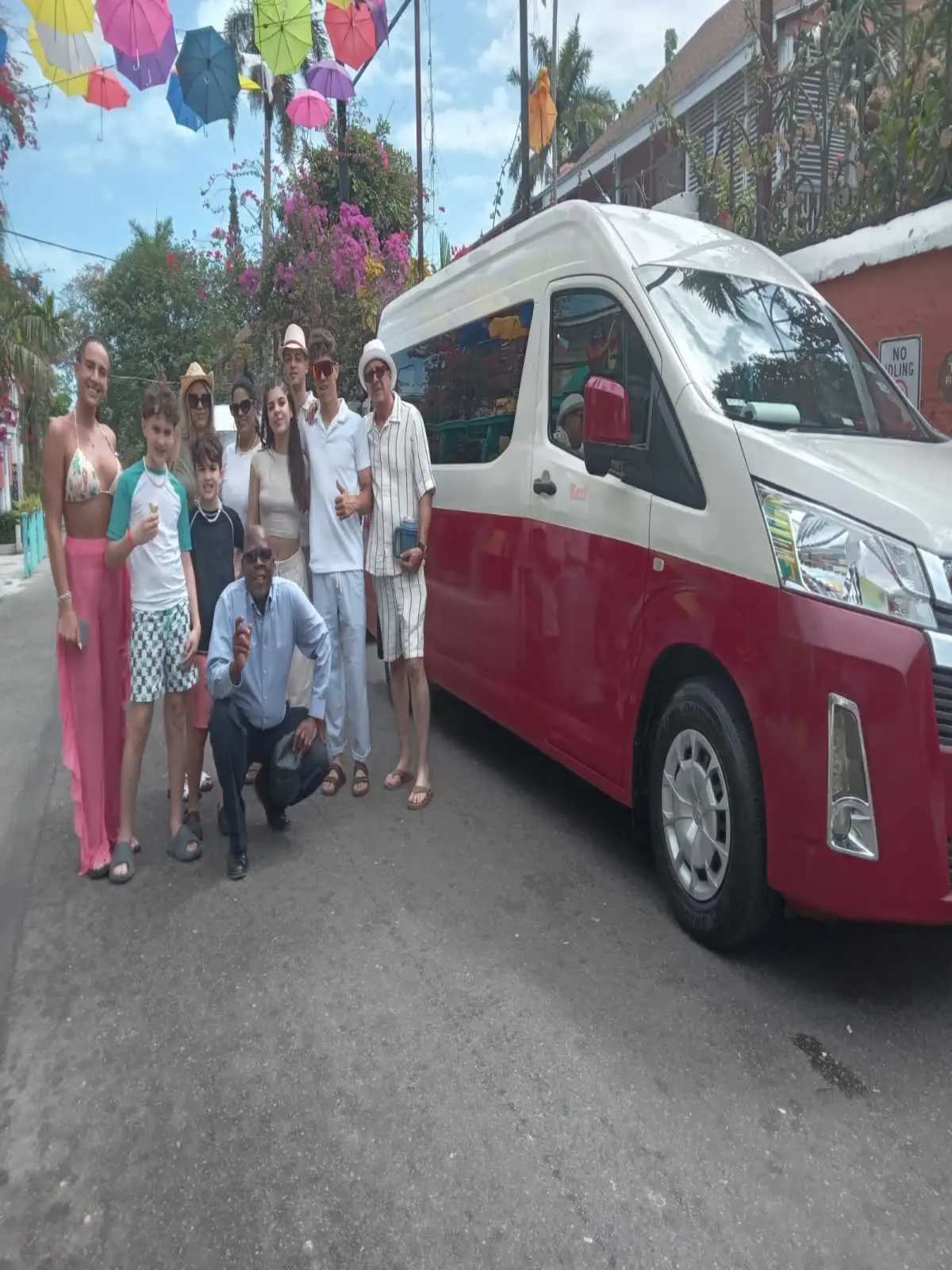 Guests gathered beside Sir Guillaume's passenger van
